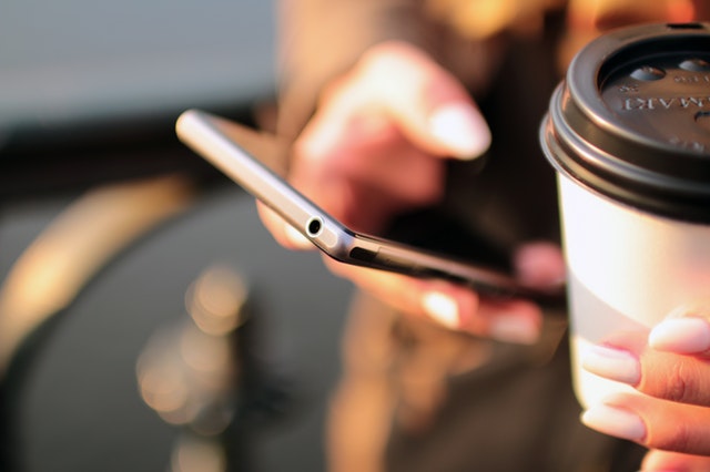 Coffee & Smartphone Contacting Think Marketly